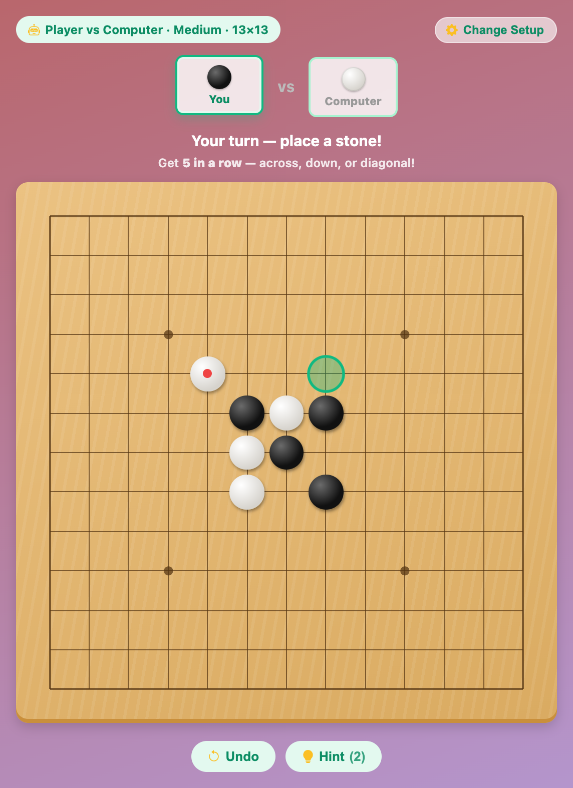 a Gomoku for kids game against the computer on the 13 by 13 board, with a green hint ring glowing