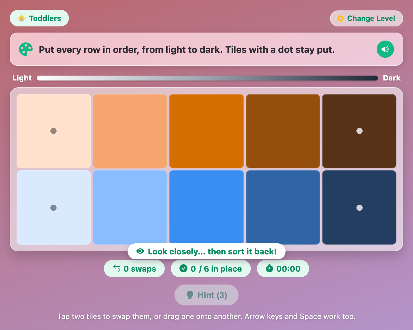 a sorted board in Rainbow Hue Sort for toddlers, with a peach-to-brown row and a pale-to-navy blue row before the shuffle